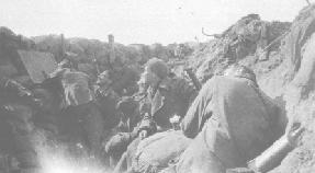 Click to enlarge: Firing a Rifle Grenade whilst watch is kept through an armoured loophole and a periscope. With the Liverpool Scottish, Spring 1915 in the Ypres Salient