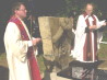Crown Copyright. Father Boni Van Looveren (l) and Canon Nicholas Frayling (r) stand beside the unveiled Liverpool Scottish memorial stone 29/07/00